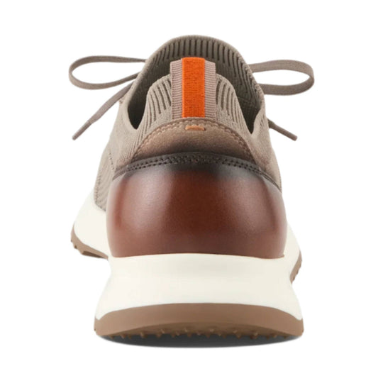 Rear view of a gray and brown sneaker with knit upper, orange heel tab, and white sole