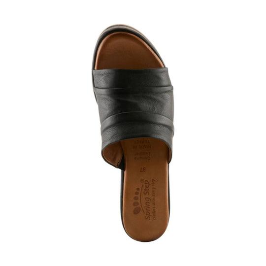 Black leather open-toe slide sandal with padded crossover straps and tan footbed