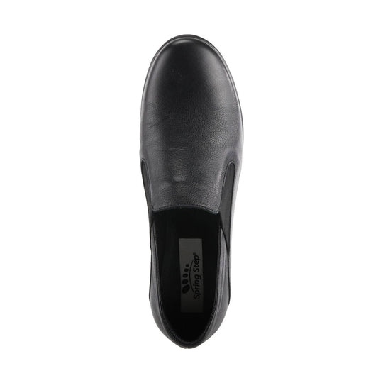 Black leather slip-on shoe seen from above with rounded toe and elastic side panels
