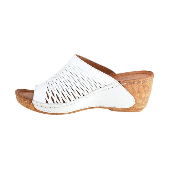 White slip-on wedge sandal with cutout upper and tan cork-look heel