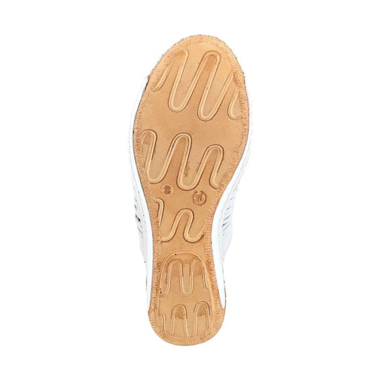 White shoe shown from the bottom with a tan rubber sole and wavy tread grooves