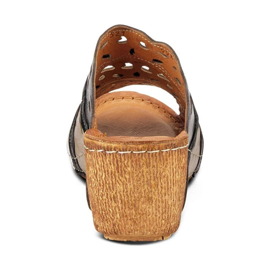 Brown wedge sandal seen from the back with cutout upper and textured wooden heel