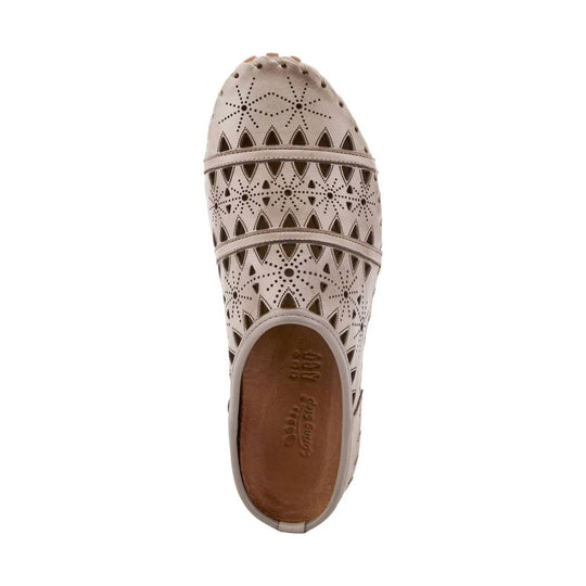 Beige perforated slip-on clog with rounded toe and cutout pattern, top view