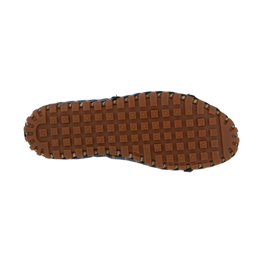 Brown lugged rubber outsole on a loafer shoe with square tread blocks
