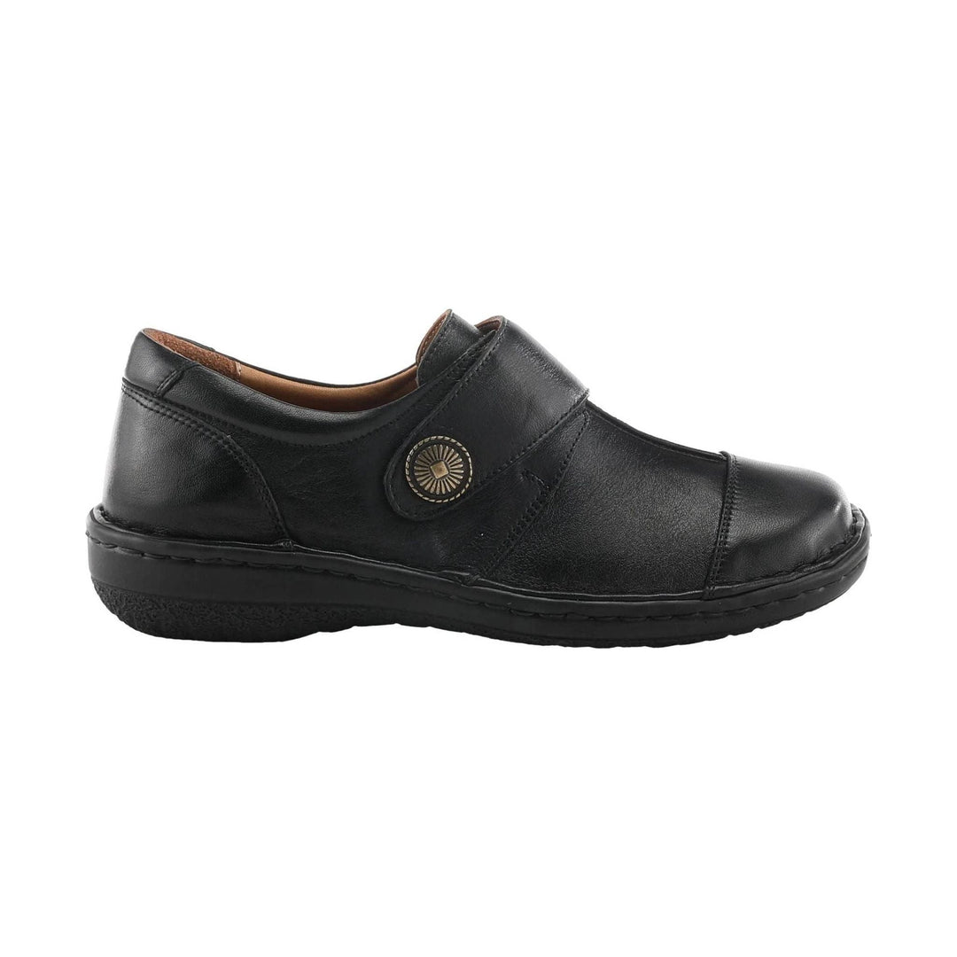 Black leather slip-on shoe with a side strap and round decorative button, shown in profile