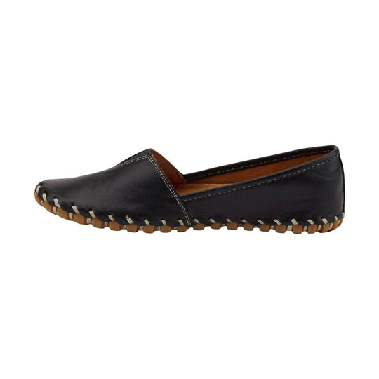 Black slip-on leather flat with tan rubber outsole and hand-stitched trim, side view
