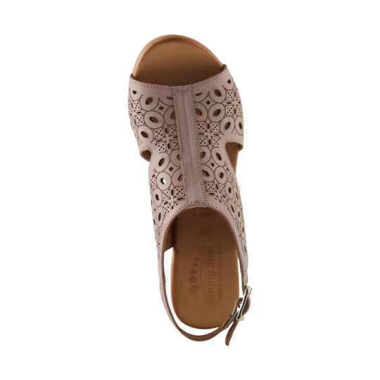 Taupe closed-toe slingback sandal with floral cutout pattern and ankle buckle
