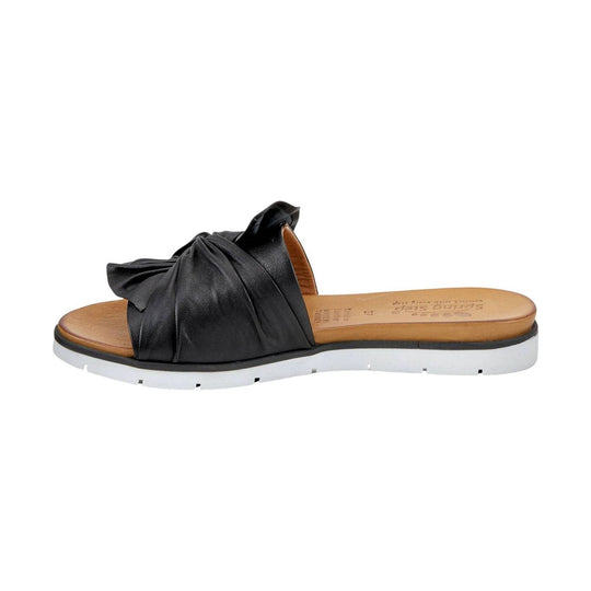 Black slip-on slide sandal with gathered upper, tan footbed, and white lug sole