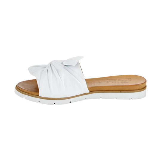White slide sandal with twisted strap and tan footbed on a white sole