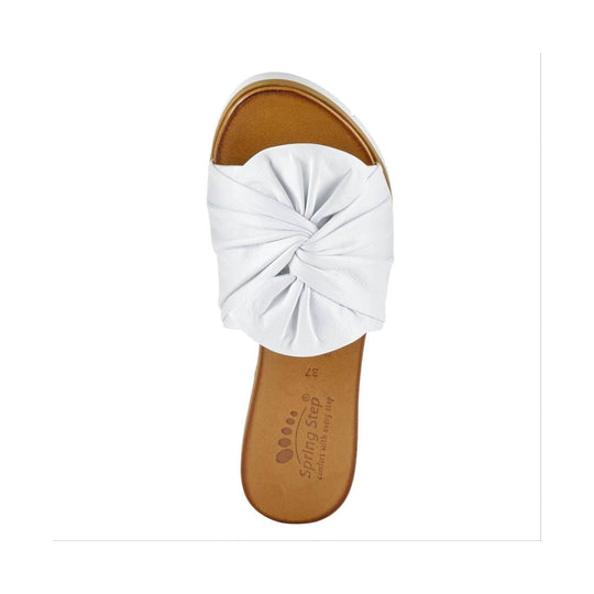 White slide sandal with twisted wide strap and tan footbed, top view