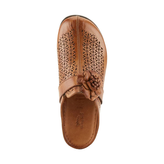 Tan perforated clog with a floral strap accent and closed toe, top view