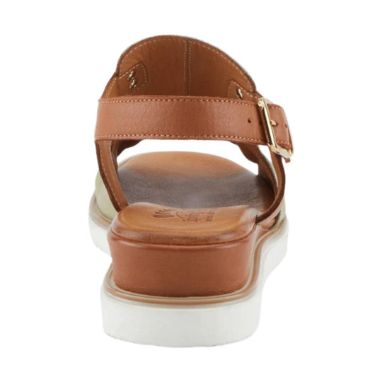 Brown leather sandal with ankle strap, gold buckle, and white platform sole, rear view
