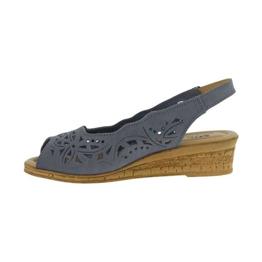 Blue closed-toe wedge sandal with floral cutouts and a tan cork-look sole