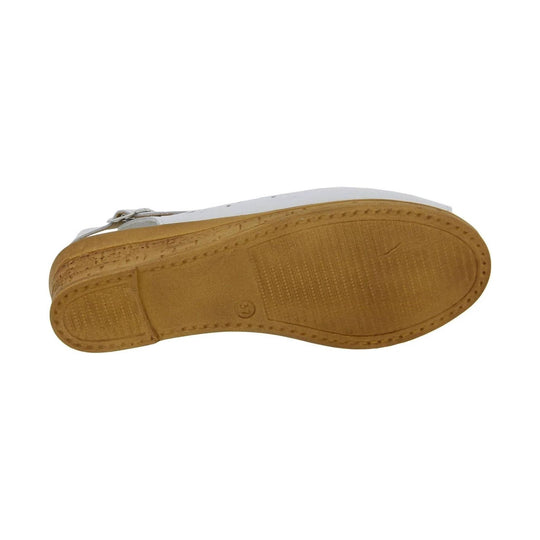 White sandal shown from below with tan rubber sole