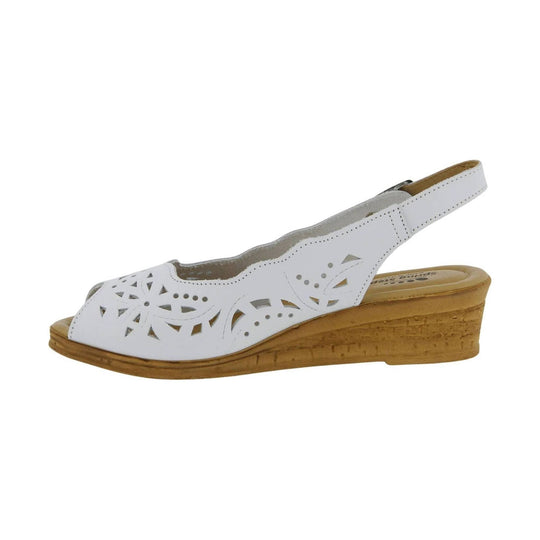 White slingback wedge sandal with floral cutout upper and tan cork-style wedge heel