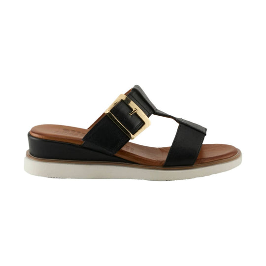 Black two-strap platform sandal with a gold buckle, tan footbed, and white sole