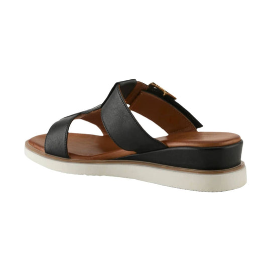 Black strappy wedge sandal with tan footbed and white sole, side view