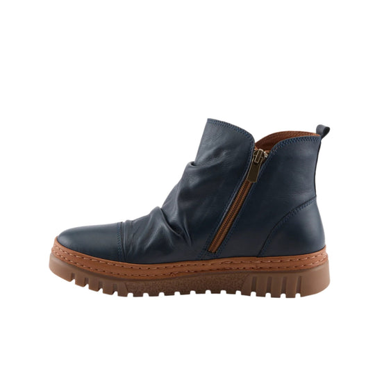 Navy ankle boot with side zipper, brown stitching, and rugged tread sole