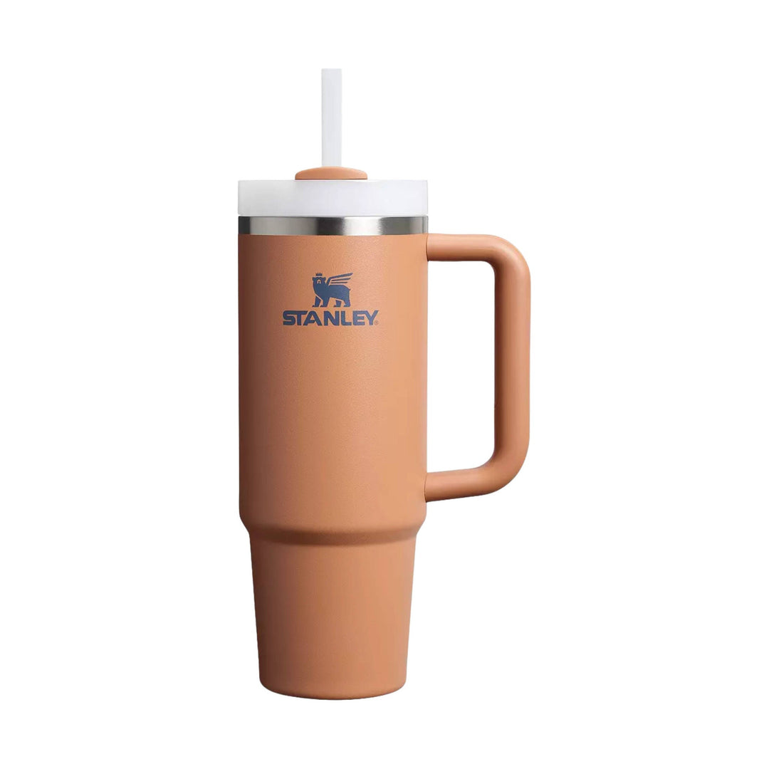 Tan insulated tumbler with handle, clear straw, and white lid, showing the Stanley logo