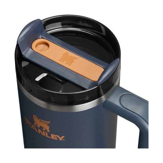 Navy insulated tumbler with black lid, orange handle, and STANLEY logo