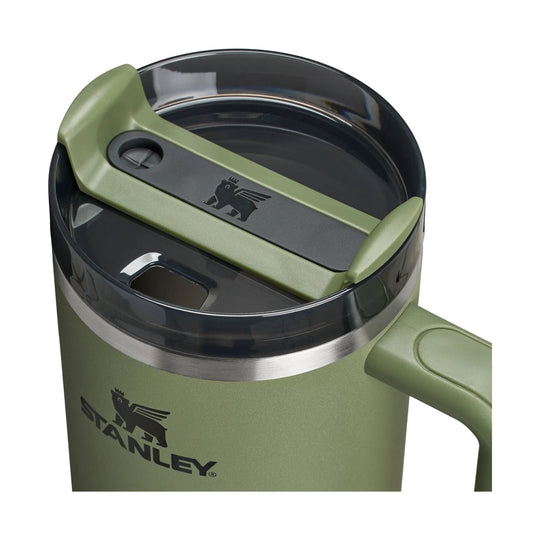 Olive green insulated tumbler with black lid and side handle, showing Stanley logo
