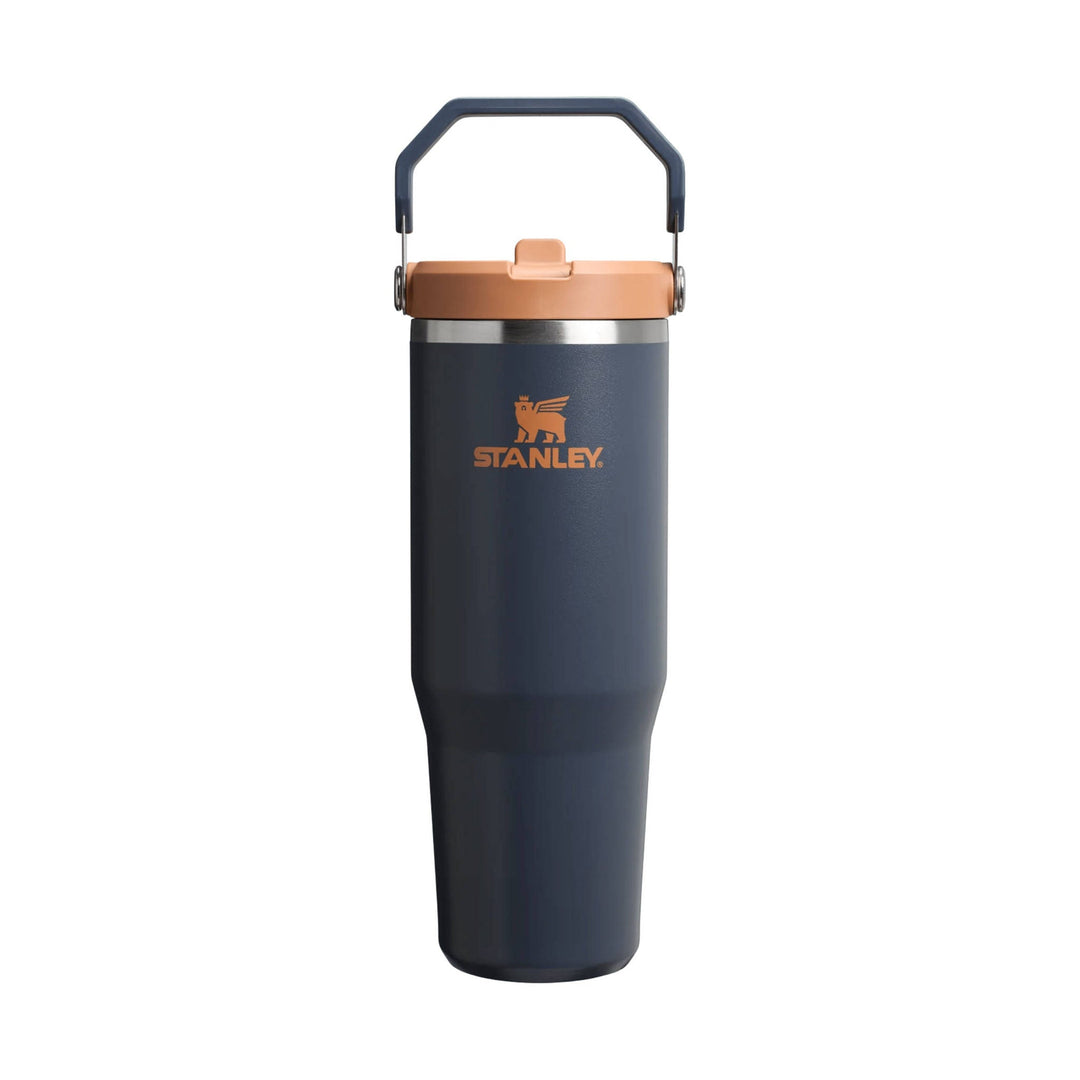 Dark navy insulated tumbler with copper lid, matching handle, and orange Stanley logo.