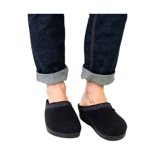Black slip-on clog with a low heel and gray cuff, shown on feet with rolled jeans