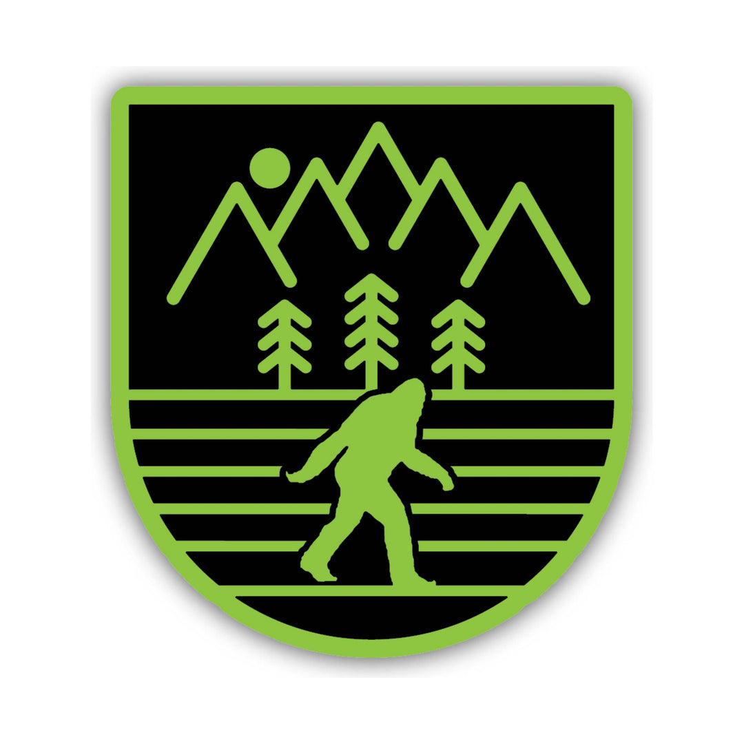 Black and neon green shield-style sticker with mountains, trees, and a Bigfoot silhouette