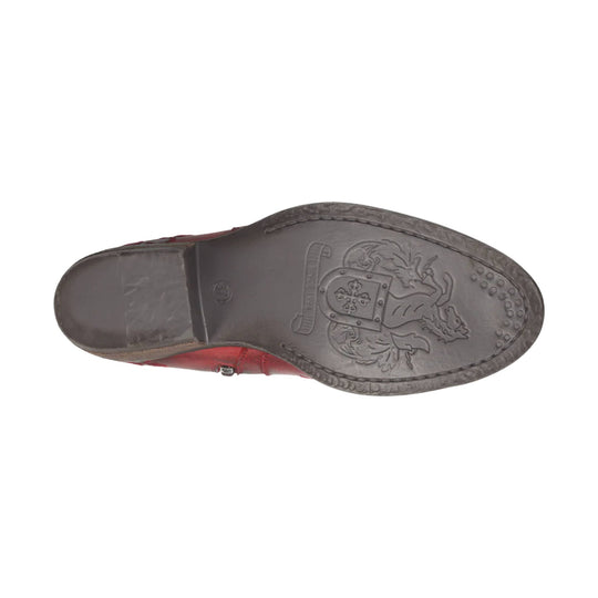 Black lugged boot sole with embossed crest and red leather upper visible at the edge