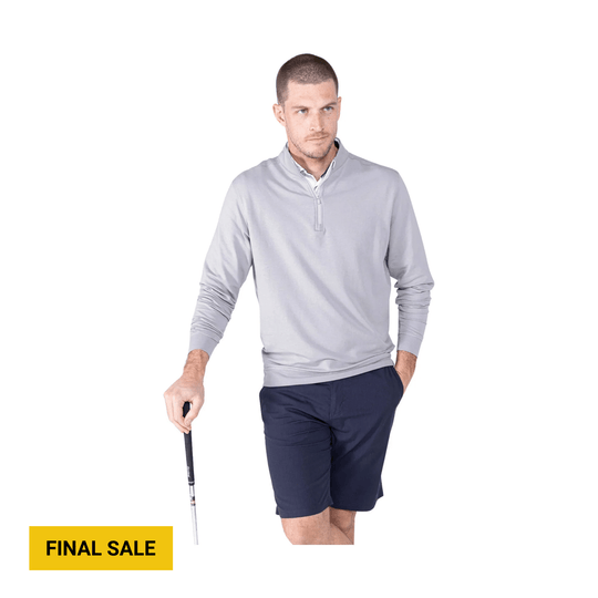 Light gray long-sleeve quarter-zip pullover with navy shorts, shown on a model holding a golf club