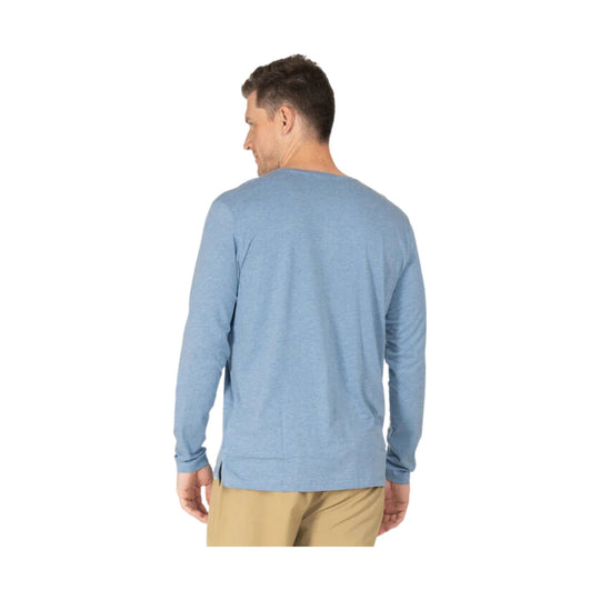 Light blue long-sleeve henley shirt shown from the back on a model