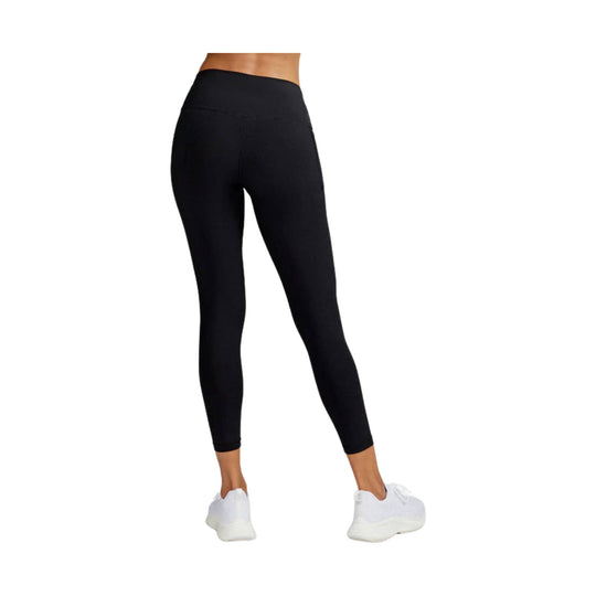 Black high-waisted 7/8 leggings with side pocket, shown on model with white sneakers