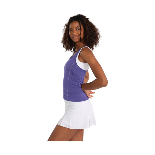 Purple racerback athletic tank top with white straps, shown with a white pleated skirt in side view