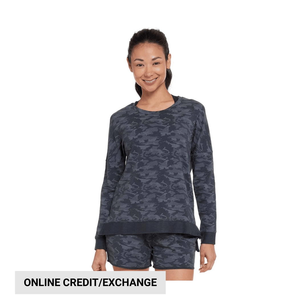 Woman wearing a dark camo long-sleeve sweatshirt and matching shorts