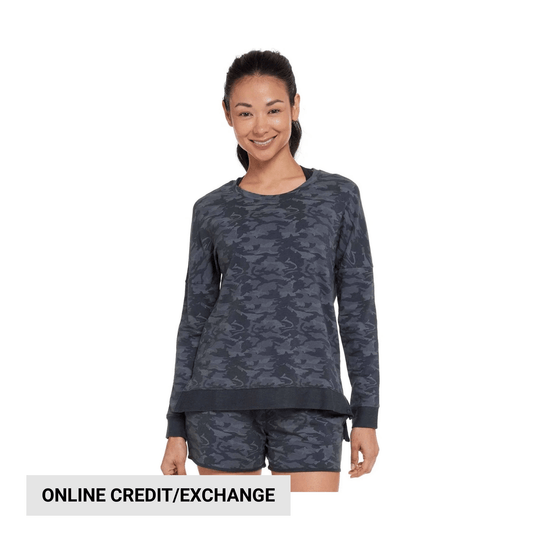 Woman wearing a dark camo long-sleeve sweatshirt and matching shorts