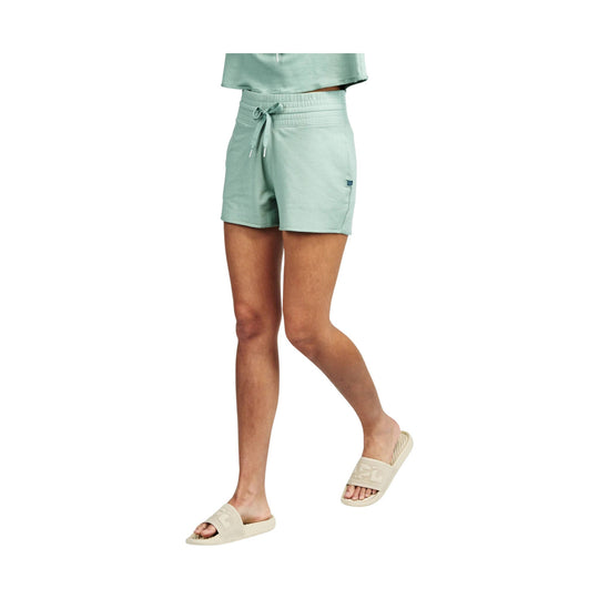 Mint green drawstring lounge shorts on a model, shown with matching top and beige slide sandals