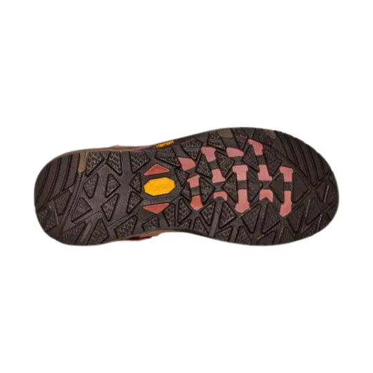 Hiking boot outsole with dark tread and pink, yellow, and coral traction zones