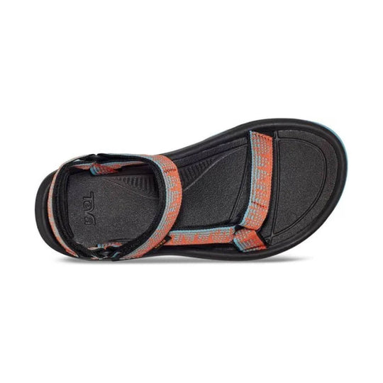 Black Teva sandal with coral and blue woven straps, shown from above