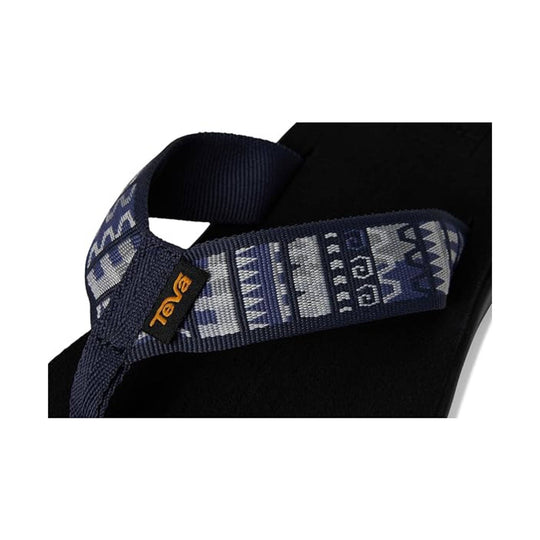 Navy patterned sandal strap with an orange Teva tag on a black footbed