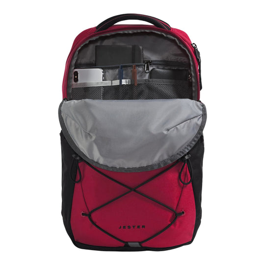 Red and black backpack with a large gray front flap pocket, open main compartment, and "JESTER" on the front