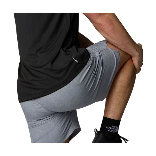 Black athletic T-shirt with FLASHDRY text near the hem, shown on a model