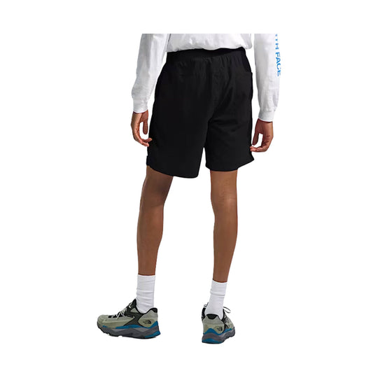 Black athletic shorts shown on a model, rear view