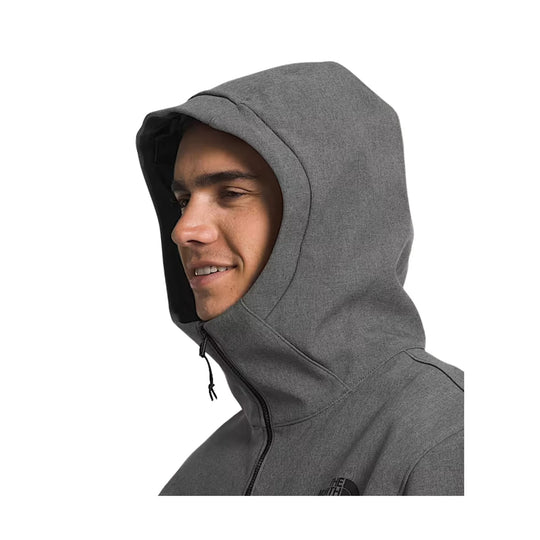 Person wearing a gray hoodie with a brand logo on a white background