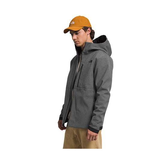 Person wearing a gray jacket and yellow cap on a white background