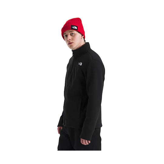 Black full-zip fleece jacket worn over black pants, shown in side view, with a red knit beanie