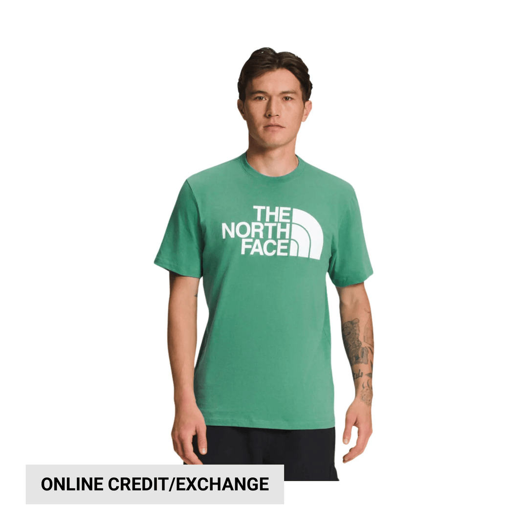 Green short-sleeve T-shirt with large white graphic text on the chest, worn by a model