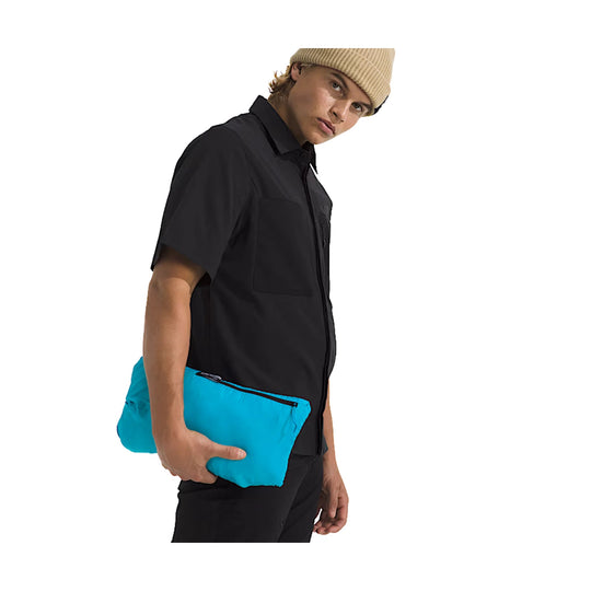 Black short-sleeve button-up shirt worn with bright blue pants, shown on a model