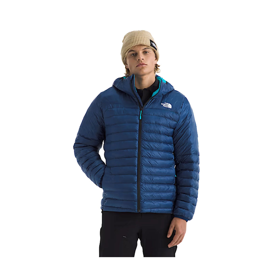 Blue quilted hooded puffer jacket with front zipper and chest logo