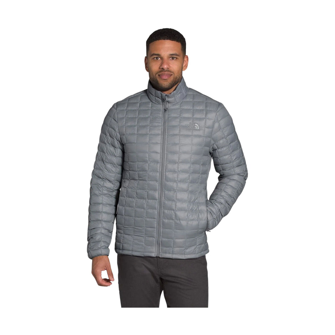 Grey quilted zip-front puffer jacket with stand collar and small chest logo