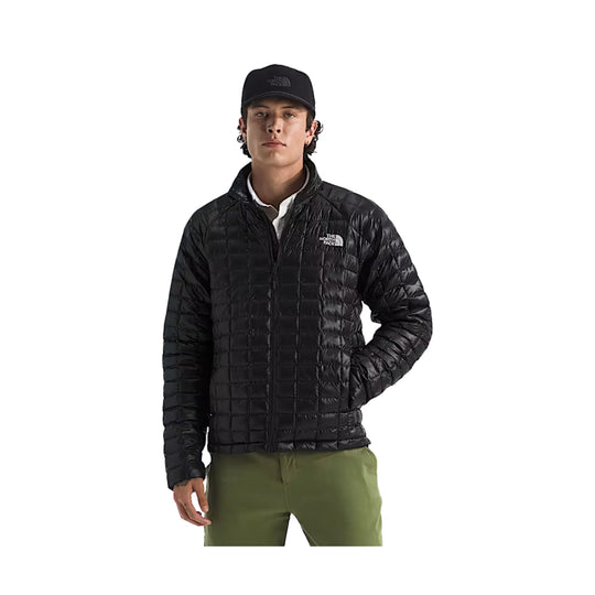 Black quilted zip-up puffer jacket worn over a white shirt, shown on a male model.